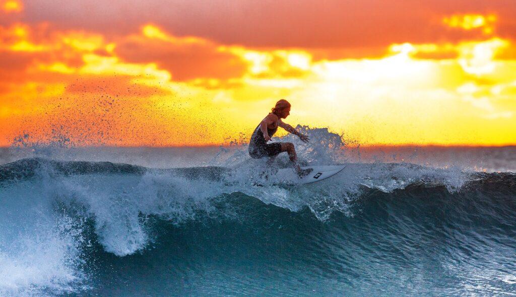 Anstrengender als man denkt. Surfen ist ein echtes Workout! Eine große Welle reiten daher ein echter Traum.